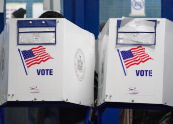 People waiting in line to vote in a small polling station at HS of Graphic Arts in Hell's Kitchen during US Presidential Election
