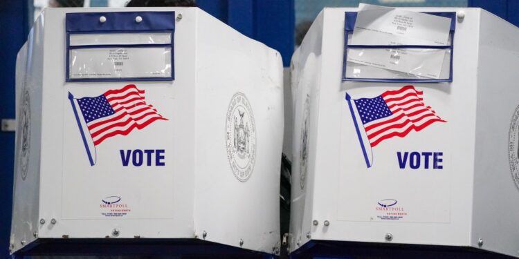 People waiting in line to vote in a small polling station at HS of Graphic Arts in Hell's Kitchen during US Presidential Election