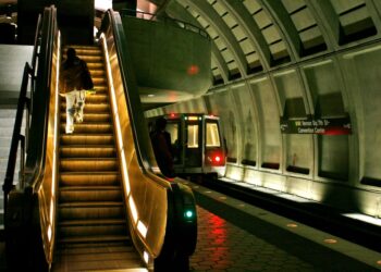 Metro rider climbs the escalator after exiting the train in the Mt. Vernon Square station where a train derailed Sunday in Washington on Monday, Jan. 8, 2007.