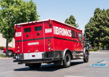 The armed pair brazenly swooped up an undetermined amount of cash from a Brinks truck outside a Cambria Heights Bank of America, police said.