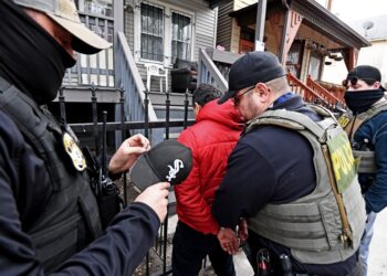 ICE officers arresting a man in Chicago.