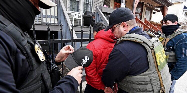 ICE officers arresting a man in Chicago.