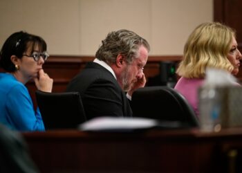 James Craig wiping his face during his murder trial.