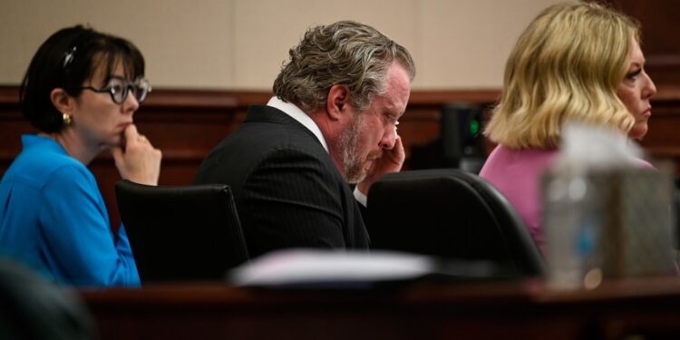 James Craig wiping his face during his murder trial.