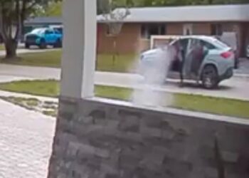 Security camera footage of a daytime shooting.