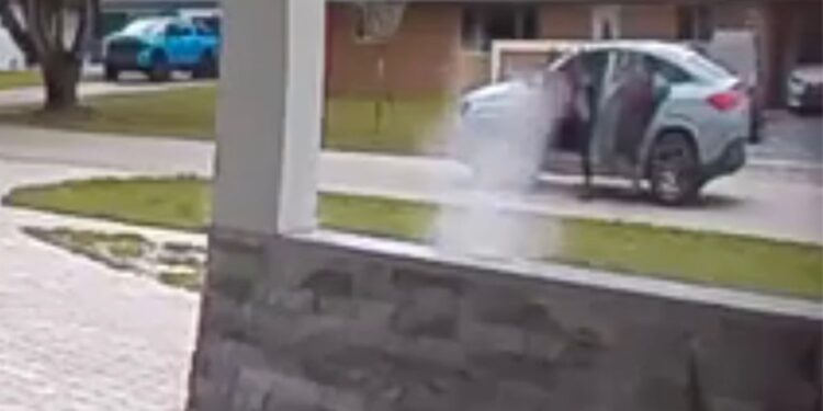 Security camera footage of a daytime shooting.