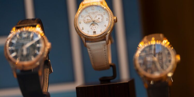 Three Patek Philippe watches on display.