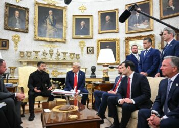 Zelensky and Trump meeting in the Oval Office with other officials.