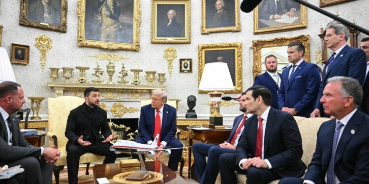 Zelensky and Trump meeting in the Oval Office with other officials.