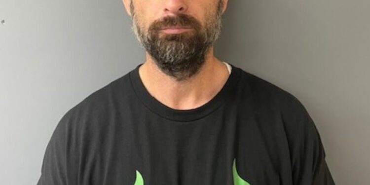 An assistant coach for a New Milford youth football team was arrested for pushing a 7-year-old player from an opposing team to the ground, police said.