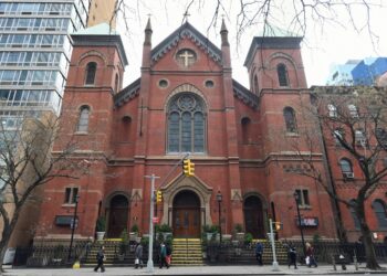 A 67-year-old worker at Holy Cross Church in Midtown was robbed by a violent duo who he'd confronted for blocking the doors, cops and sources said.