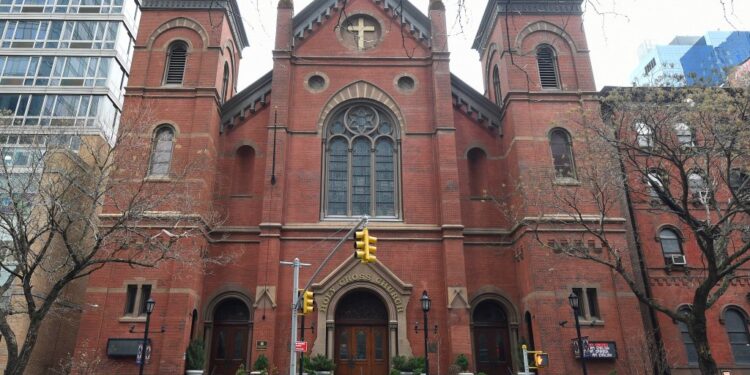A 67-year-old worker at Holy Cross Church in Midtown was robbed by a violent duo who he'd confronted for blocking the doors, cops and sources said.