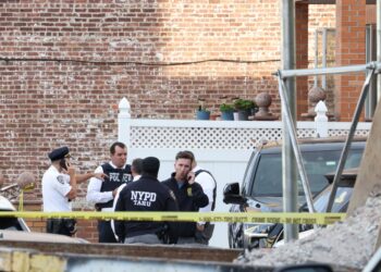 NYPD officers at a crime scene at 45-18 Smart Street in Queens, NY.