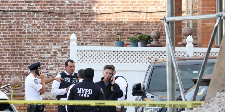 NYPD officers at a crime scene at 45-18 Smart Street in Queens, NY.