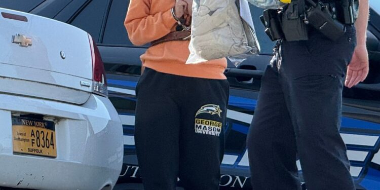 Amanda Kempton in handcuffs, appearing in court for a hit and run.