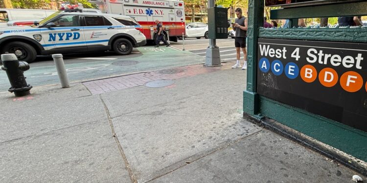 A police car and an ambulance are seen at the West 4th St. subway station in Manhattan, Friday, May 2, 2025. A man was stabbed on an F train during an argument with another person.