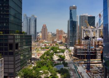 New York, USA - July 9, 2019: View of New York from a famous Vessel, designed by architect Thomas Heatherwick, at the Hudson Yards district in Manhattan on summer day.