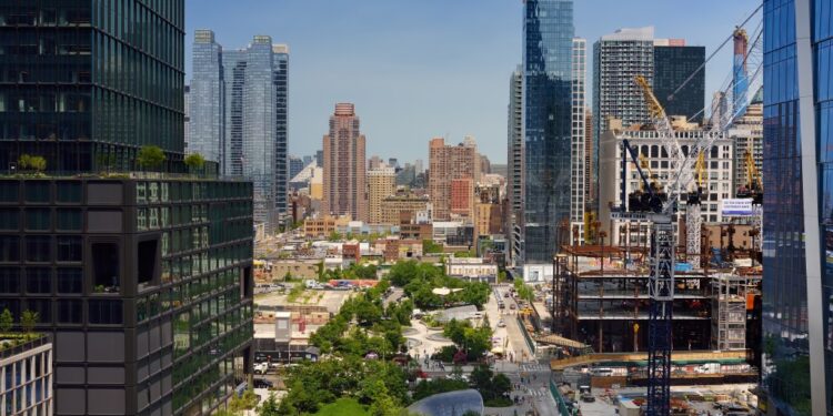 New York, USA - July 9, 2019: View of New York from a famous Vessel, designed by architect Thomas Heatherwick, at the Hudson Yards district in Manhattan on summer day.