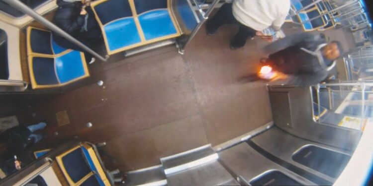 Surveillance video captured a train rider identified as Lawrence Reed holding a flaming bottle before his fire attack on Nov. 17, 2025.