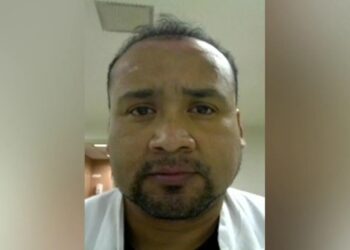 A close-up of Humberto Munoz Gatica facing forward, with a short goatee and dark hair, wearing a white shirt.