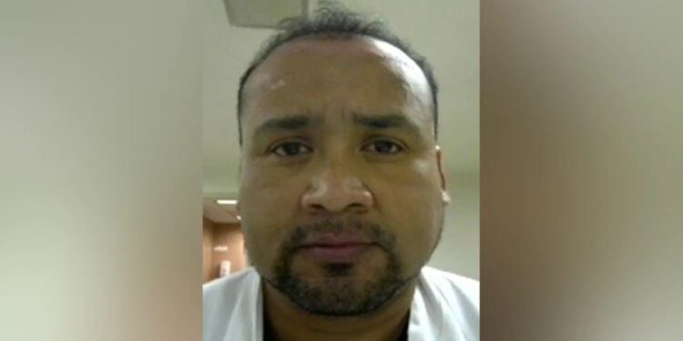 A close-up of Humberto Munoz Gatica facing forward, with a short goatee and dark hair, wearing a white shirt.