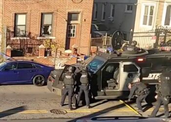 Police barricade a Brooklyn apartment with an armored vehicle after shots were fired.