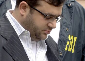 Eliyahu Weinstein being escorted by FBI agents.