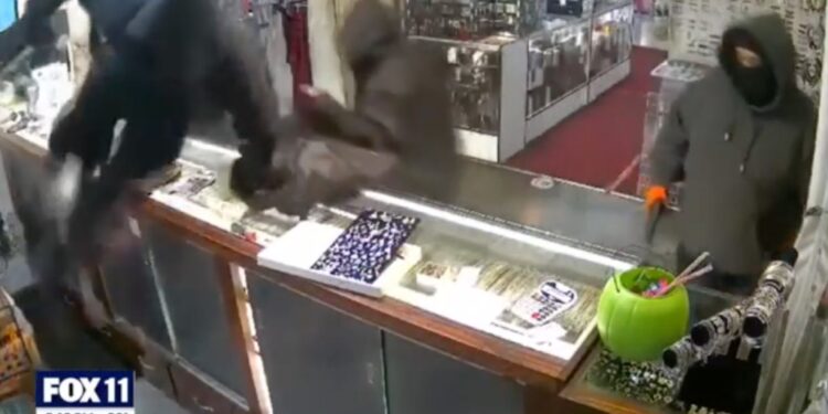 Video shows the thieves smashing the counter glass and filling up bags with merchandise.