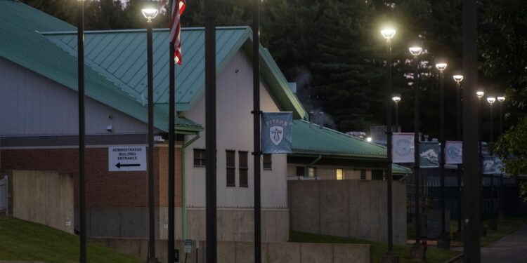 A photo shows the exterior of a residential treatment facility with a light-green roof at dawn.