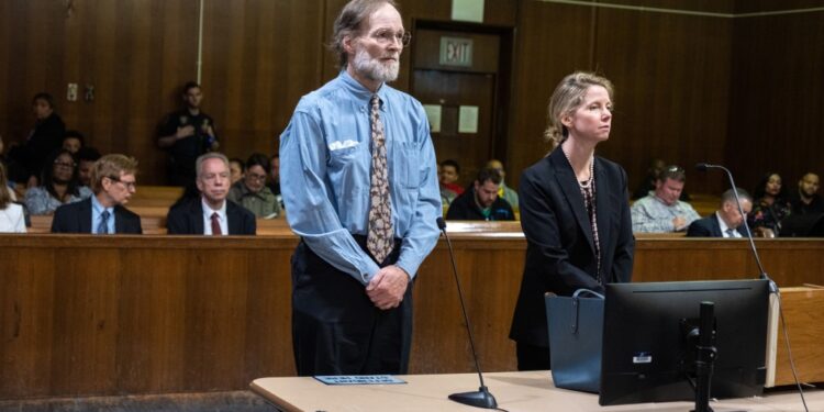Charles Foehner standing in court next to a woman in a black suit.