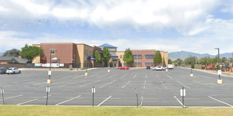 Hawthorn Academy building with a parking lot in front.